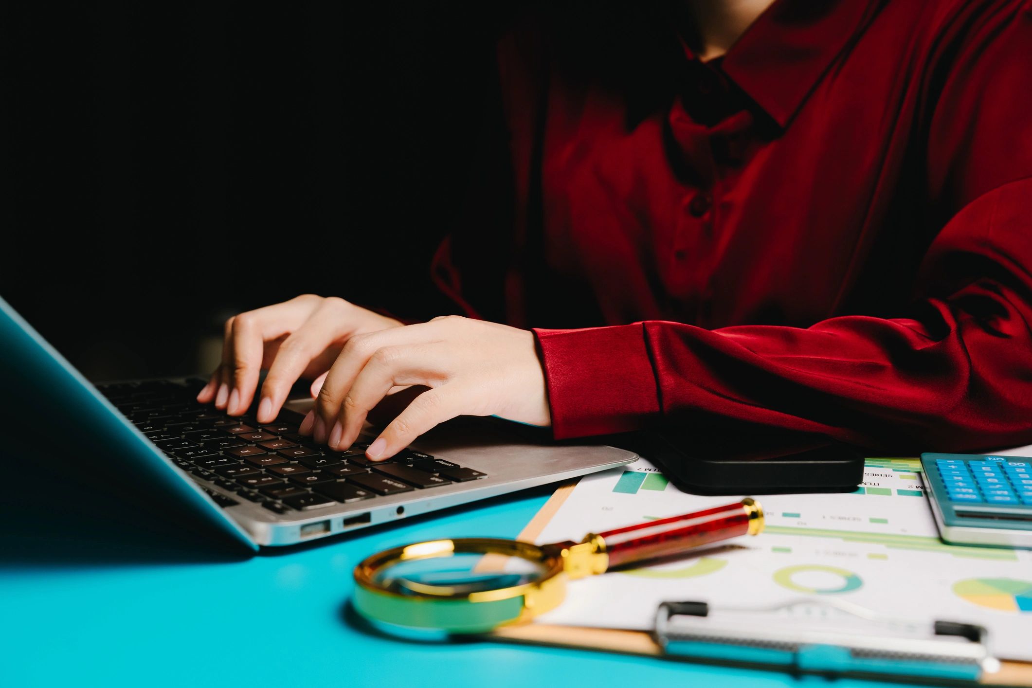 Hands typing on a laptop keyboard during analysis work